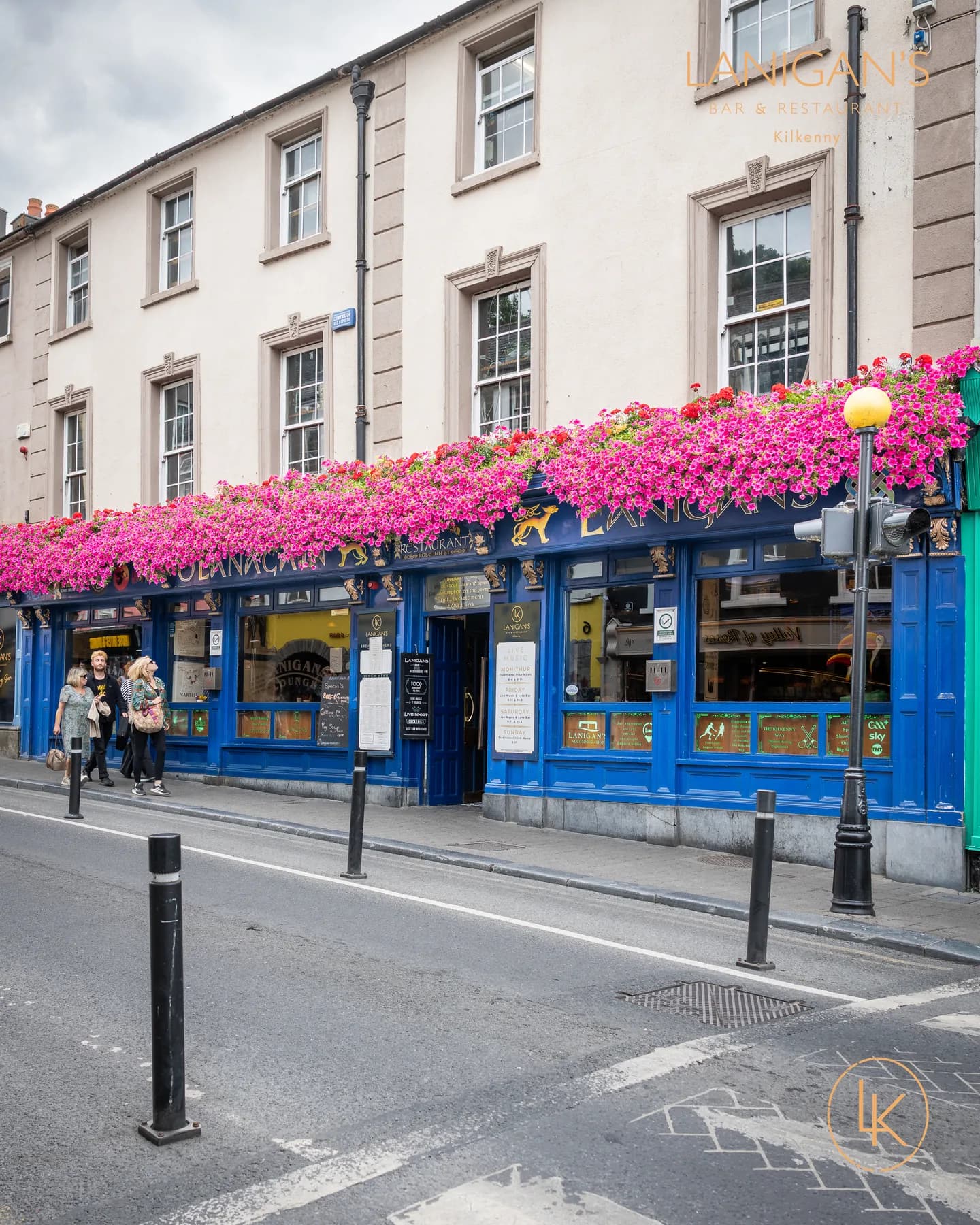 The royal-blue flower-topped frontage of Lanigan's Bar & Restaurant on Rose Inn Street, Kilkenny